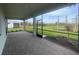 Covered patio with screened in enclosure and beautiful landscaping views of manicured grass at 5014 Coastal Oak Ct, Lakewood Ranch, FL 34211