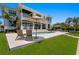 Expansive backyard featuring a pool, lounge area, and manicured lawn perfect for outdoor relaxation and entertaining at 5110 W Longfellow Ave, Tampa, FL 33629
