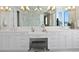 Bright bathroom featuring double sinks, vanity, marble countertop and accents, and chandelier lighting at 5110 W Longfellow Ave, Tampa, FL 33629
