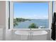 Bright bathroom showing a free standing tub next to a window with beautiful water views at 5110 W Longfellow Ave, Tampa, FL 33629