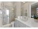 Bright bathroom featuring a glass shower, vanity with modern fixtures, and a view at 5110 W Longfellow Ave, Tampa, FL 33629