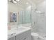 Modern bathroom with a glass shower, marble accents, and a grey vanity at 5110 W Longfellow Ave, Tampa, FL 33629