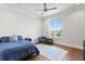 Cozy bedroom featuring hardwood floors, a blue bed set, and a water view at 5110 W Longfellow Ave, Tampa, FL 33629
