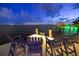 Waterfront living with a private boat dock featuring seating and vibrant green lights at night at 5110 W Longfellow Ave, Tampa, FL 33629