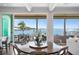 Elegant dining area with waterfront views, hardwood floors, and an open layout connected to the living space at 5110 W Longfellow Ave, Tampa, FL 33629
