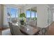 Elegant dining room with water view, large windows, designer drapes, and stylish chairs at 5110 W Longfellow Ave, Tampa, FL 33629