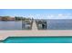 Waterfront property featuring a private dock with boat and jet ski lifts, adjacent to a refreshing swimming pool at 5110 W Longfellow Ave, Tampa, FL 33629
