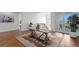Second story entryway featuring an area rug, wooden floors, and balcony access at 5110 W Longfellow Ave, Tampa, FL 33629