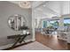 Elegant entryway featuring a round mirror, chandelier, console table, and an open view to the water at 5110 W Longfellow Ave, Tampa, FL 33629