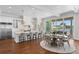 Gourmet kitchen with a large island, stainless steel appliances, and adjacent dining area overlooking the waterfront at 5110 W Longfellow Ave, Tampa, FL 33629