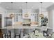 Bright kitchen features custom white cabinets, stainless appliances, and a large island with marble countertops at 5110 W Longfellow Ave, Tampa, FL 33629