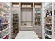 Walk-in pantry with custom shelving, wine storage, marble countertops, and ample storage space at 5110 W Longfellow Ave, Tampa, FL 33629
