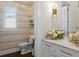 Stylish powder room with elegant wallpaper, modern fixtures, and a marble countertop at 5110 W Longfellow Ave, Tampa, FL 33629