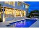 Elegant rear exterior showcasing a pool, covered patio, and lush landscaping, perfect for outdoor entertaining at 5110 W Longfellow Ave, Tampa, FL 33629