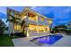 A luxurious home boasts a stunning backyard oasis featuring a sparkling pool and covered patio space at 5110 W Longfellow Ave, Tampa, FL 33629
