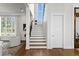Bright staircase with hardwood treads, white risers, a large window, and access to the second floor at 5110 W Longfellow Ave, Tampa, FL 33629