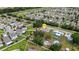 An aerial view showing a home's layout, solar panels, and proximity to a neighborhood and nearby road at 5250 Brody Blvd, Wimauma, FL 33598