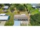 Aerial view of the property showing the house with a well maintained yard and mature trees at 5250 Brody Blvd, Wimauma, FL 33598