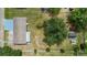 Bird's-eye view of the residence highlighting its spacious yard, mature trees, and ample parking at 5250 Brody Blvd, Wimauma, FL 33598
