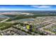 Stunning aerial view of the property with neighborhood, lake, and convenient access to nearby highway at 5250 Brody Blvd, Wimauma, FL 33598