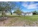 Lush backyard with mature trees, creating a serene and private outdoor space at 5250 Brody Blvd, Wimauma, FL 33598