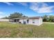 Backyard with screened porch, offering a relaxing outdoor space at 5250 Brody Blvd, Wimauma, FL 33598