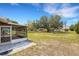 Expansive backyard featuring mature trees, patio, and a shed at 5250 Brody Blvd, Wimauma, FL 33598