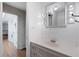 Clean bathroom with lighted vanity mirror and white fixtures at 5250 Brody Blvd, Wimauma, FL 33598