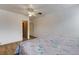Clean bedroom featuring neutral walls, ceiling fan and an adjacent closet at 5250 Brody Blvd, Wimauma, FL 33598
