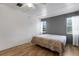 Bright bedroom with ample natural light from two windows and ceiling fan at 5250 Brody Blvd, Wimauma, FL 33598