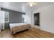 Cozy bedroom with wood-look floors, ceiling fan, and bright windows for natural light at 5250 Brody Blvd, Wimauma, FL 33598