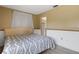 Bedroom featuring a patterned bedspread, pale yellow walls and light-colored trim at 5250 Brody Blvd, Wimauma, FL 33598