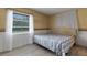 Bright bedroom features a large window, white curtains, and comfortable bed at 5250 Brody Blvd, Wimauma, FL 33598