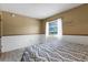 Bright bedroom features a large window, white curtains, and comfortable bed at 5250 Brody Blvd, Wimauma, FL 33598