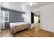 Bedroom featuring a bed, hardwood floors, and access to the garage at 5250 Brody Blvd, Wimauma, FL 33598