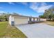 Charming home exterior with a well-maintained lawn, showcasing curb appeal at 5250 Brody Blvd, Wimauma, FL 33598