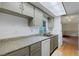 Kitchen featuring laminate counters, white appliances and light gray cabinets at 5250 Brody Blvd, Wimauma, FL 33598