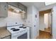 Bright kitchen features a white stove, tiled backsplash, and neutral countertops at 5250 Brody Blvd, Wimauma, FL 33598