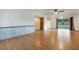 Open living room with hardwood floors, ceiling fan, sliding glass doors, and a white refrigerator at 5250 Brody Blvd, Wimauma, FL 33598