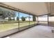 Covered patio overlooking the spacious backyard with greenery at 5250 Brody Blvd, Wimauma, FL 33598