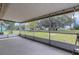 Screened patio looking out to a spacious backyard with mature trees at 5250 Brody Blvd, Wimauma, FL 33598