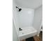 Clean and modern bathroom with white tiled shower and black fixtures at 5654 12Th St, Zephyrhills, FL 33542