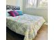 Inviting bedroom featuring hardwood floors, a bright window, and fresh paint at 5654 12Th St, Zephyrhills, FL 33542