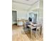 Open-concept dining room with views to the kitchen, table, and seating for four at 5654 12Th St, Zephyrhills, FL 33542