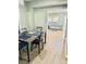 Dining room with hardwood floors and view into living room at 5654 12Th St, Zephyrhills, FL 33542