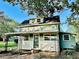 Charming two-story home with covered front porch and decorative iron railings at 5654 12Th St, Zephyrhills, FL 33542