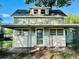 Charming two-story home with covered front porch and decorative iron railings at 5654 12Th St, Zephyrhills, FL 33542