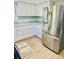 Kitchen featuring white cabinets, stainless steel refrigerator, and granite countertops at 5654 12Th St, Zephyrhills, FL 33542