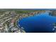 A scenic view of homes lining a waterfront with docks and boats surrounded by lush greenery at 610 Winterside Dr, Apollo Beach, FL 33572