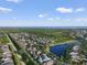 A beautiful aerial view showcasing homes in a community near a lush forest and waterfront at 610 Winterside Dr, Apollo Beach, FL 33572